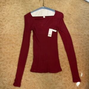 Woman’s rose colored v neck sweater.97% viscous 3% spandex